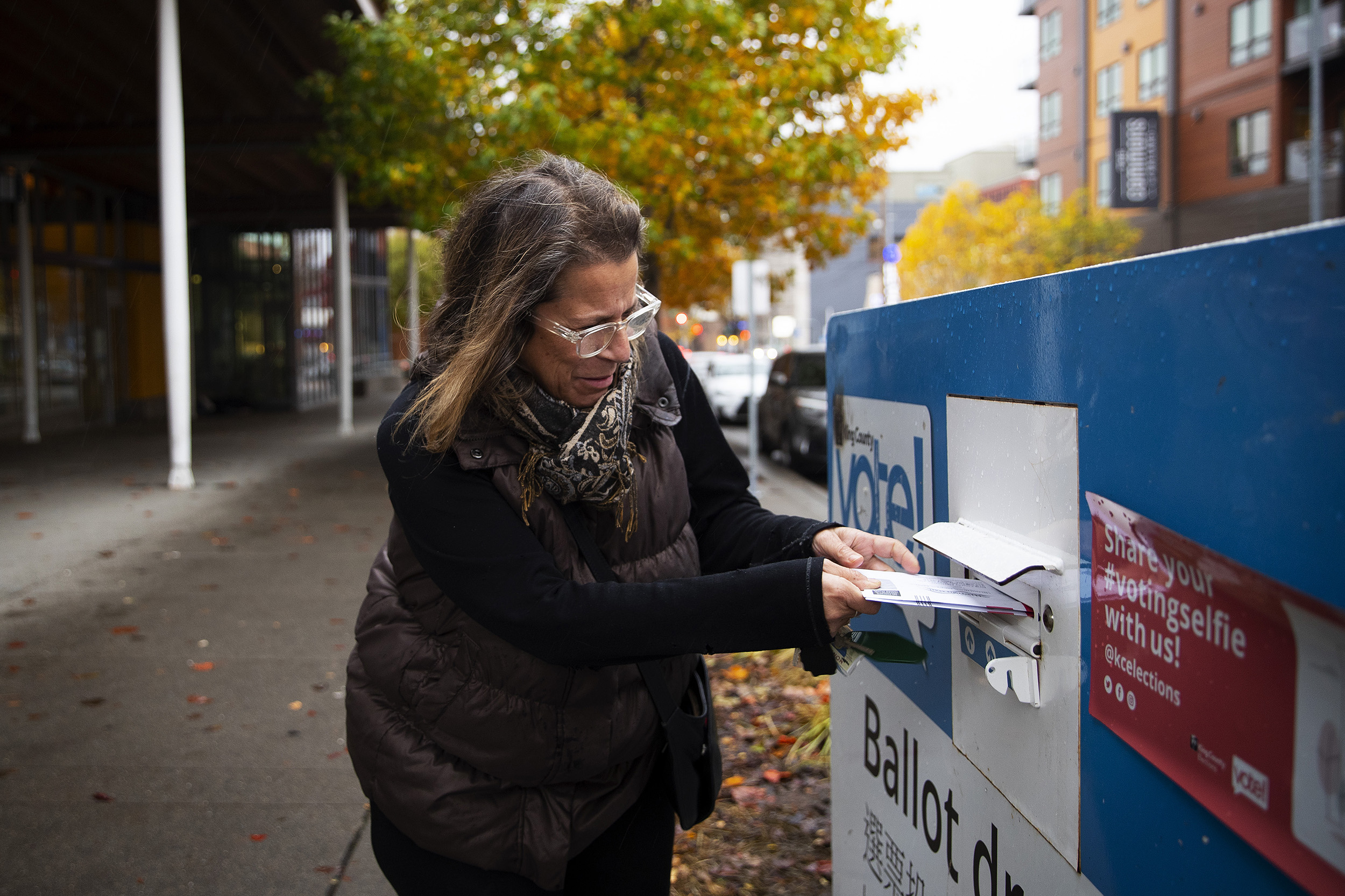 caption: Elizabeth Kaye Sortun casts her ballot on Monday, November 7, 2022, outside of the Ballard branch of the Seattle Public Library in Seattle. 