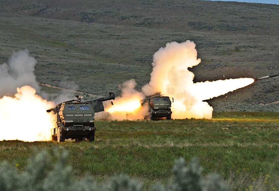 caption: Soldiers fire two rounds from their High Mobility Artillery Rocket systems at Yakima Training Center in 2011.