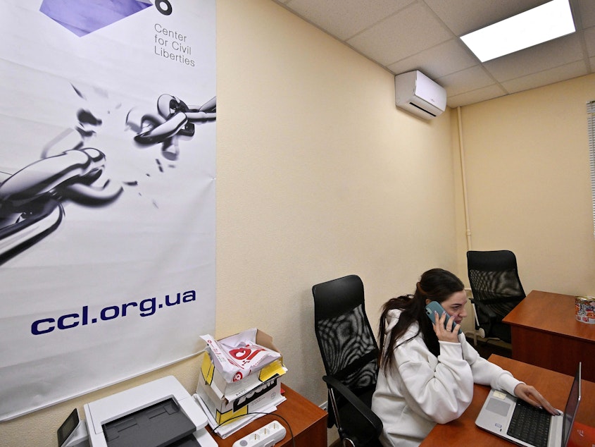 caption: An employee of Ukraine's Center for Civil Liberties works in the office in Kyiv on Friday.