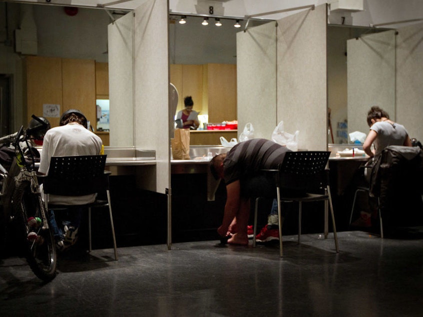 caption: Addicts inject themselves in May 2011 at the Insite supervised injection center in Vancouver, Canada.