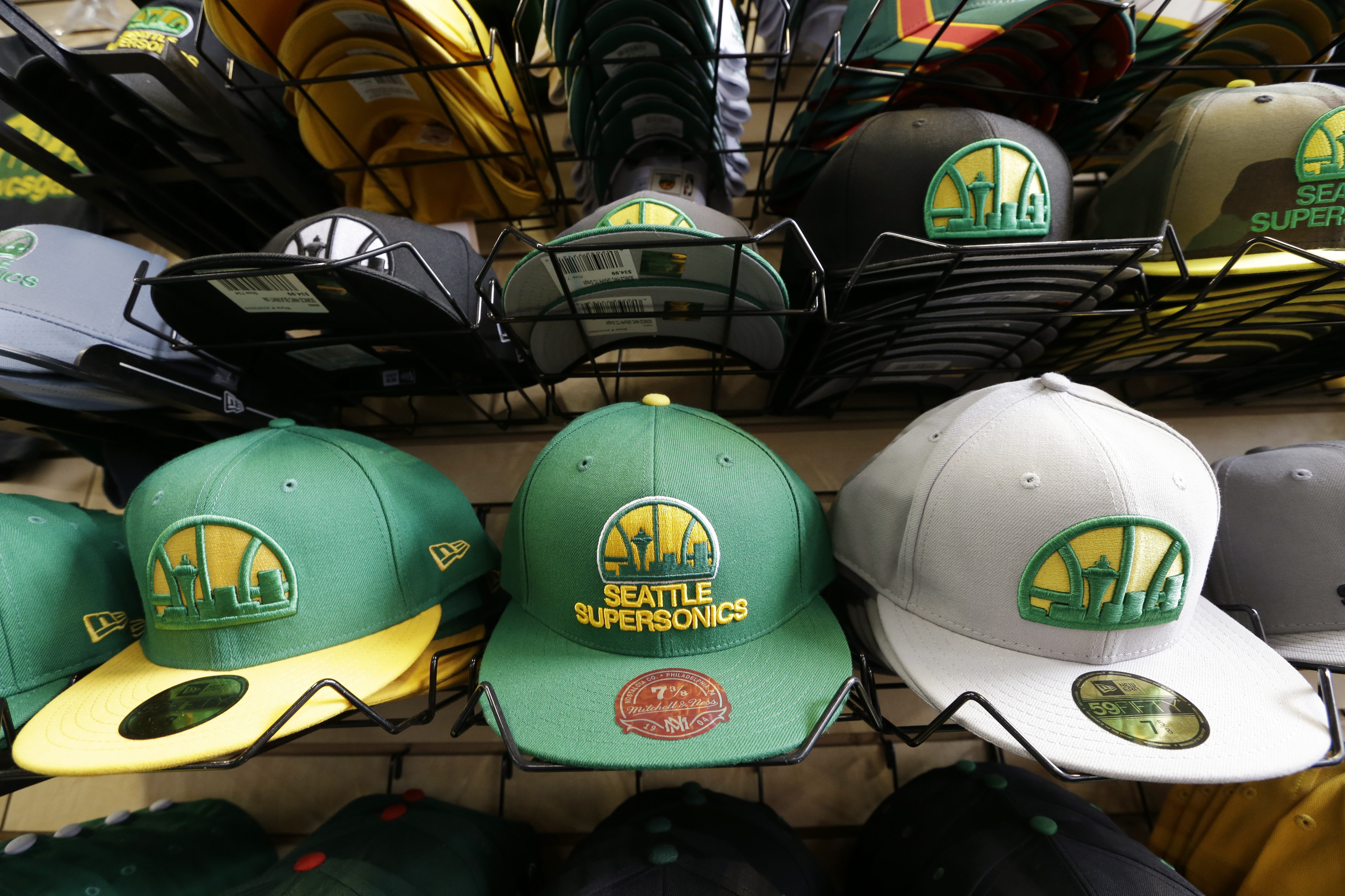caption: FILE - Stacks of Seattle SuperSonics caps are displayed in a shop, Wednesday, May 15, 2013 in Seattle.
