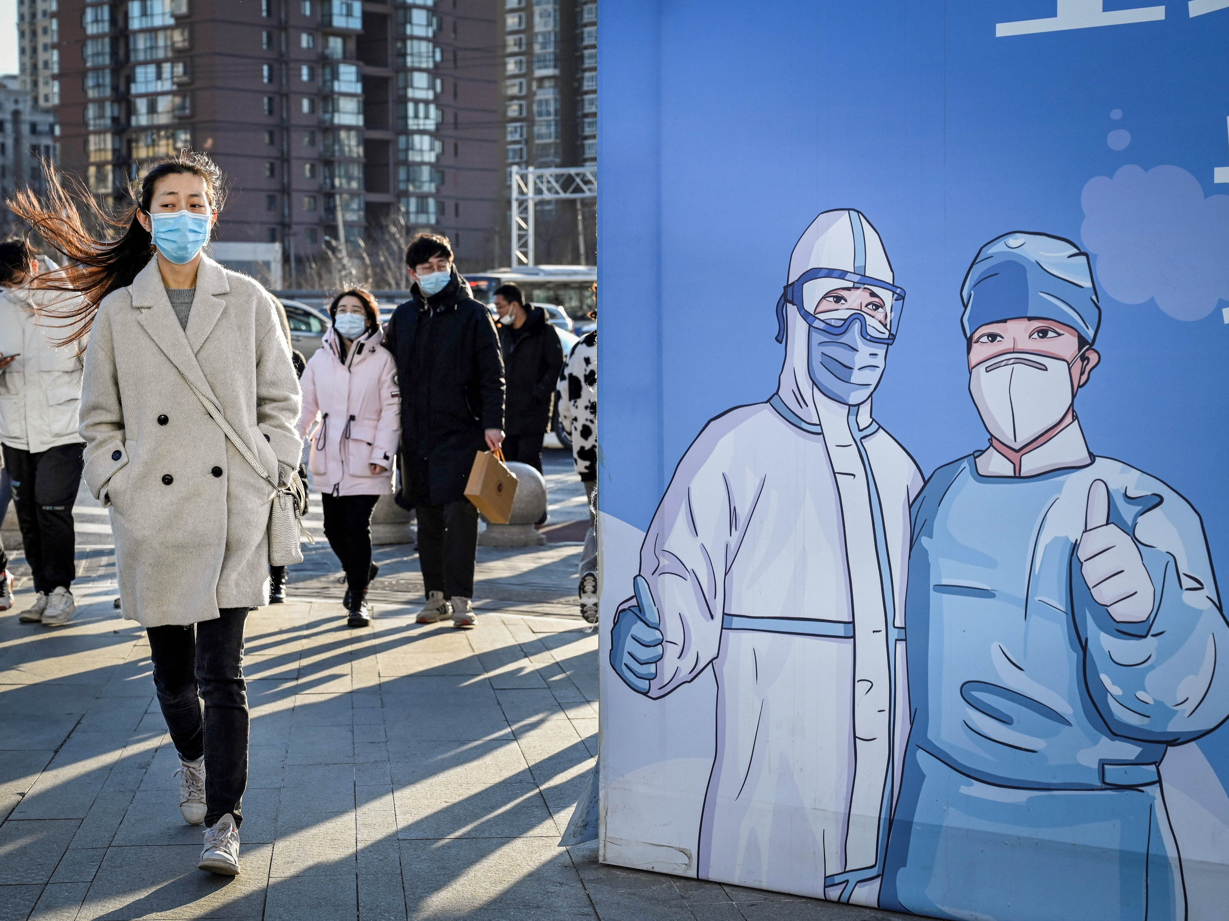 A billboard in Beijing promotesi vaccination. The problem of under-vaccination is most acute among the elderly. According to the government, around 30% of people aged 60 and up — roughly 80 million people — were not vaccinated and boosted as of Nov. 11.