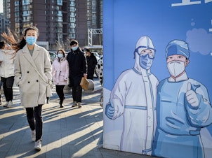 A billboard in Beijing promotesi vaccination. The problem of under-vaccination is most acute among the elderly. According to the government, around 30% of people aged 60 and up — roughly 80 million people — were not vaccinated and boosted as of Nov. 11.