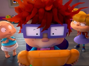 caption: Pictured: Tommy Dewey as Stu Pickles, Nancy Cartwright as Chuckie Finster and Cheryl Chase as Anjelica Pickles of the Paramount+ series <em>Rugrats</em>.