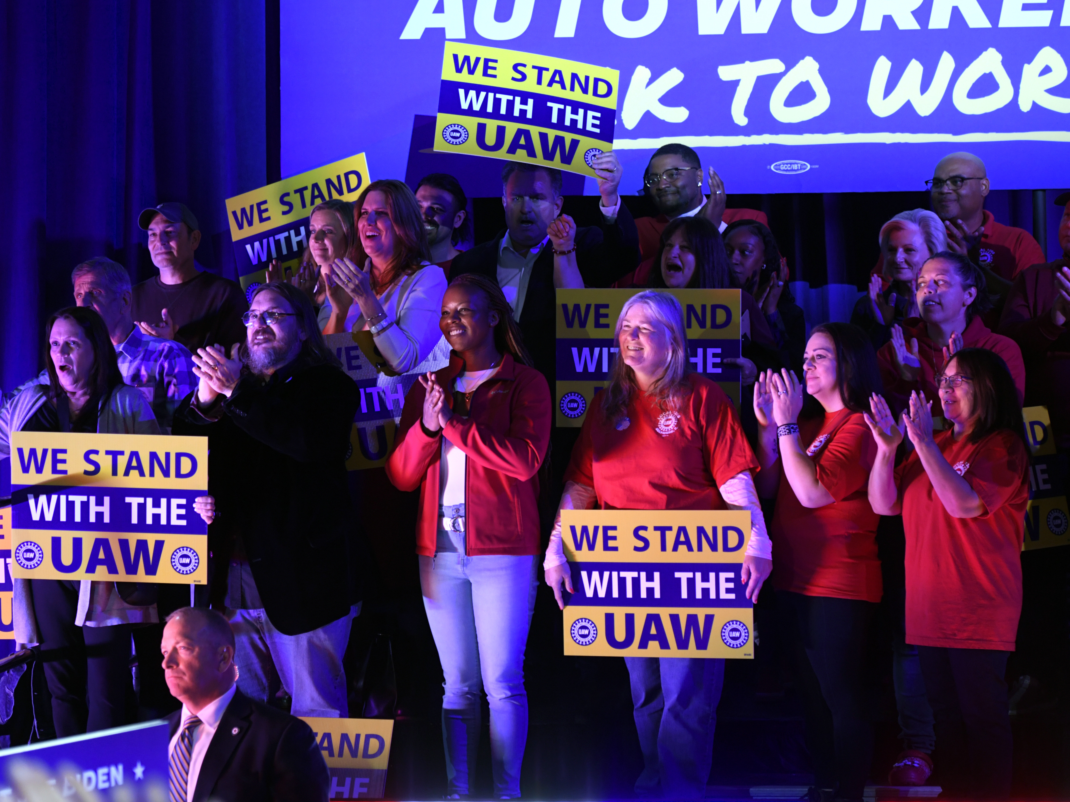 caption: Union members listen as President Joe Biden speaks to United Auto Workers at the Community Building Complex of Boone County, on Nov. 9, in Belvidere, Ill.