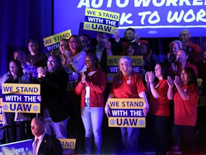 caption: Union members listen as President Joe Biden speaks to United Auto Workers at the Community Building Complex of Boone County, on Nov. 9, in Belvidere, Ill.