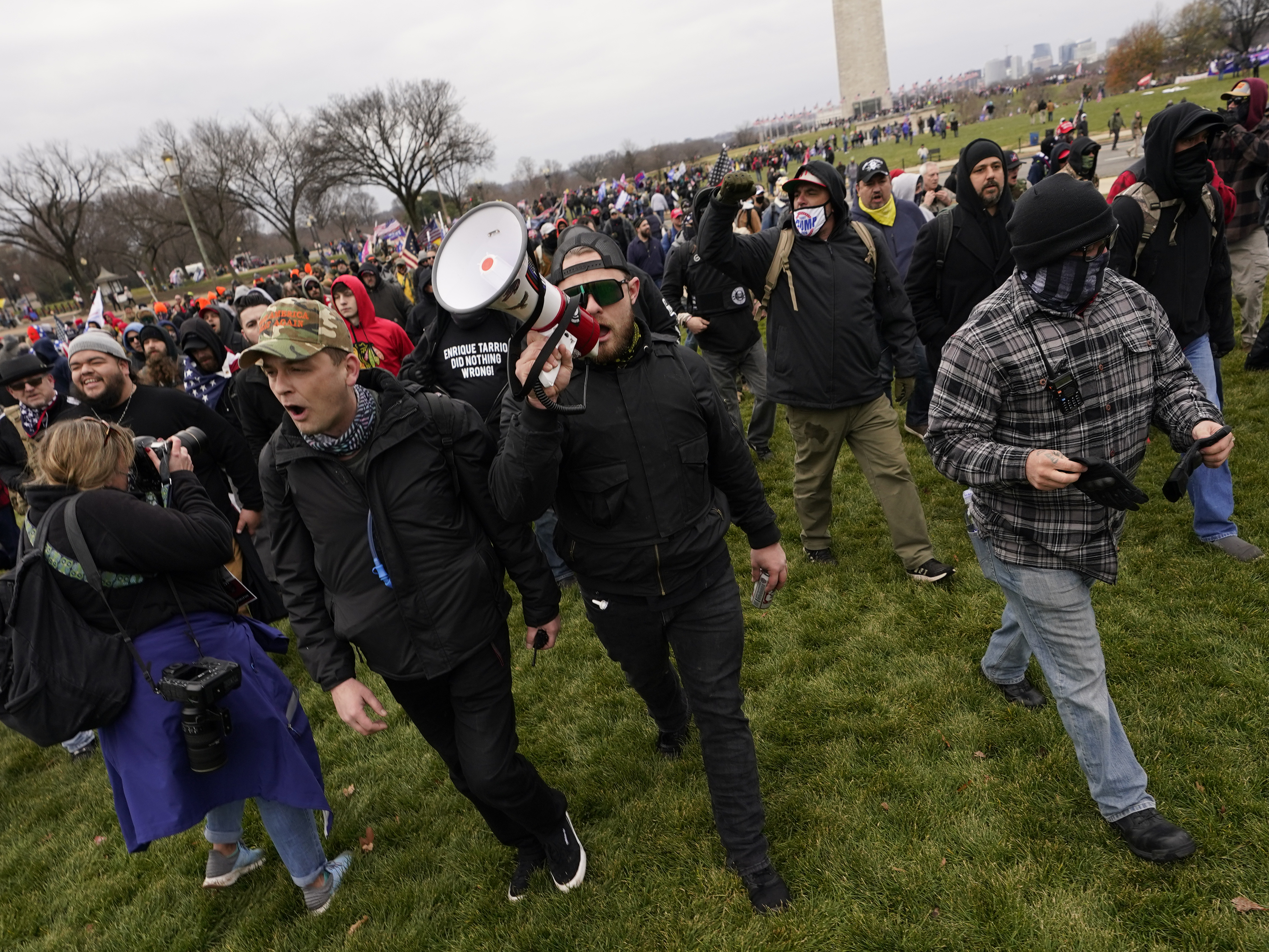 caption: Ethan Nordean, pictured on Jan. 6 with backward baseball hat and bullhorn, leads members of the far-right group Proud Boys in marching before the riot at the U.S. Capitol. Nordean, 30, of Auburn, Washington, has described himself as the sergeant-of-arms of the Seattle chapter of the Proud Boys.