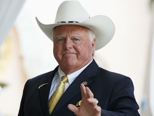 caption: The Texas Department of Agriculture has handed down a new dress code for its employees — mandating they follow with it in a "manner consistent with their biological gender." Here in this Dec. 30, 2016, file photo, Texas Agriculture Commissioner Sid Miller waves as he arrives at Mar-a-Lago to meet with President-elect Donald Trump's transition team in Palm Beach, Fla.