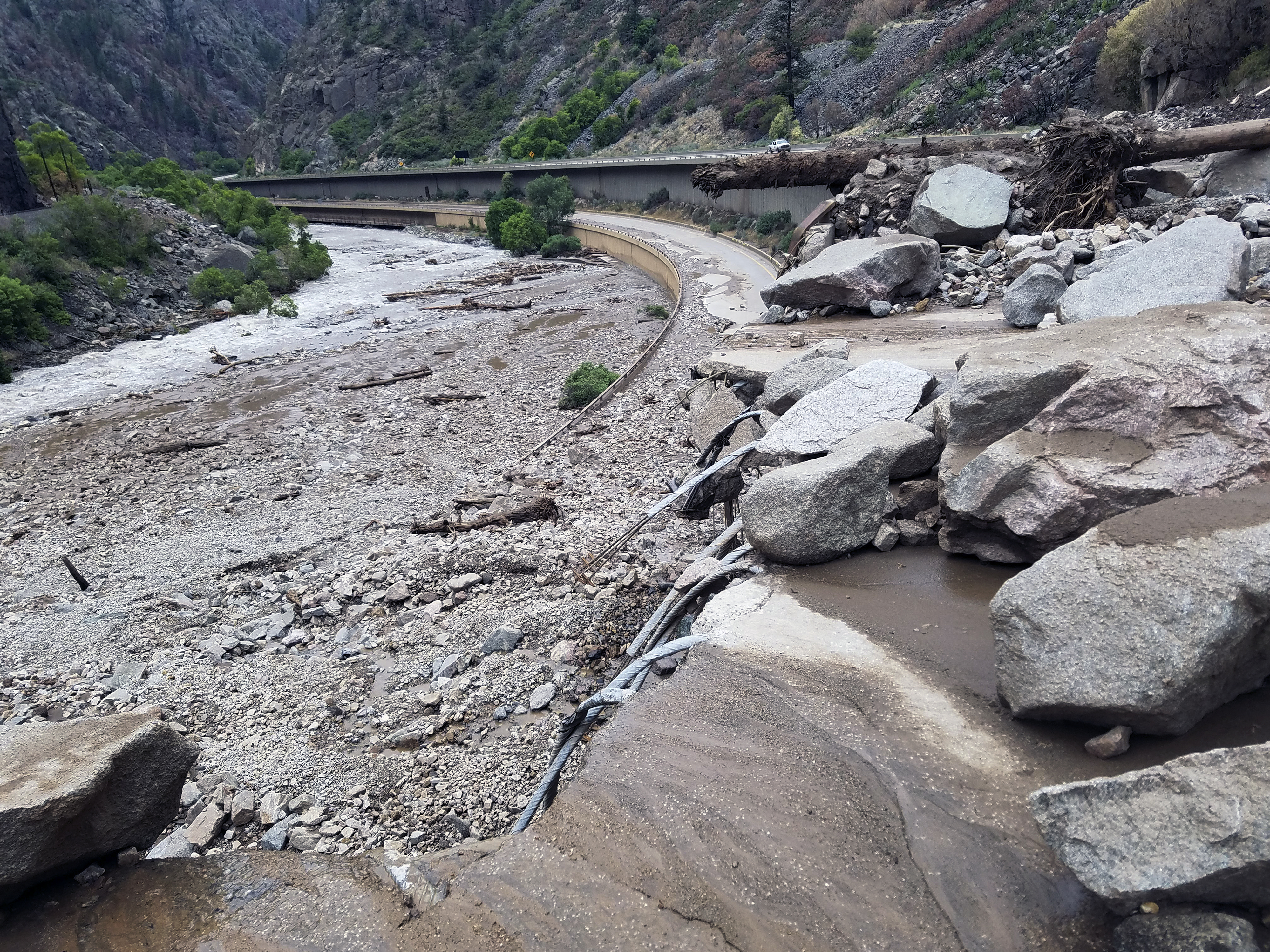 caption: Mud and debris on Sunday on U.S. Highway 6 west of Silver Plume, Colo.