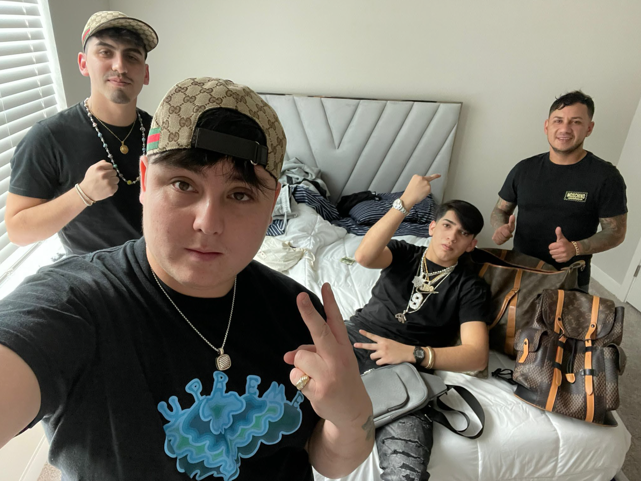 caption: The FBI says this photograph, taken the day after NFL quarterback Joe Burrow's house was burglarized, shows several suspects in the crime with items that were reported stolen, including Burrow's jewelry bearing his jersey number, 9. The agency believes the theft was the work of a South American crime ring.