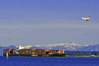 caption: The Zim Kingston at anchor near Nanaimo, British Columbia, on Jan. 9, with gaps visible where shipping containers had spilled or been offloaded after being damaged in a fire. 