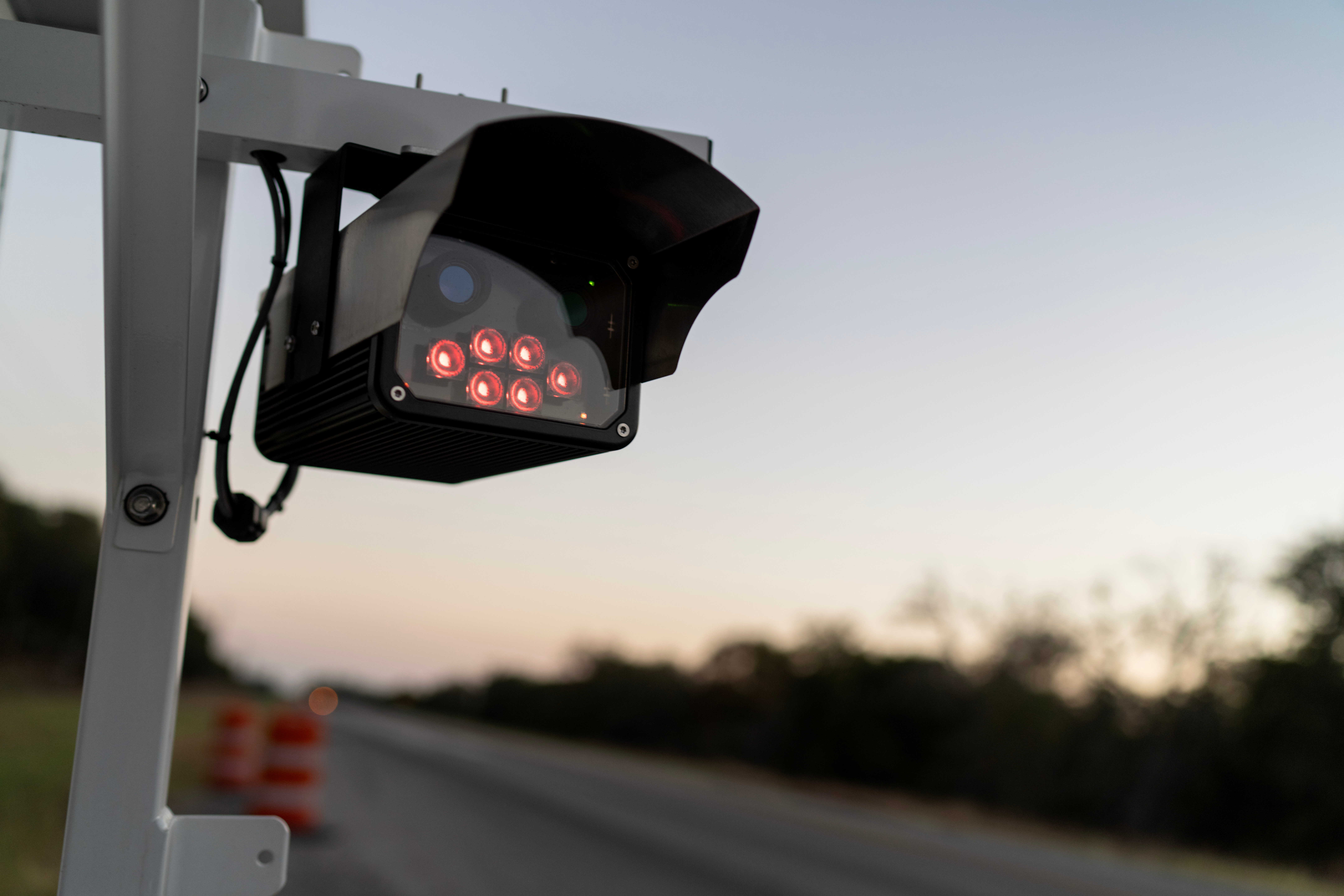 caption: A license plate reader stands along the side of a road, Wednesday, Oct. 15, 2025, in Stockdale, Texas. 