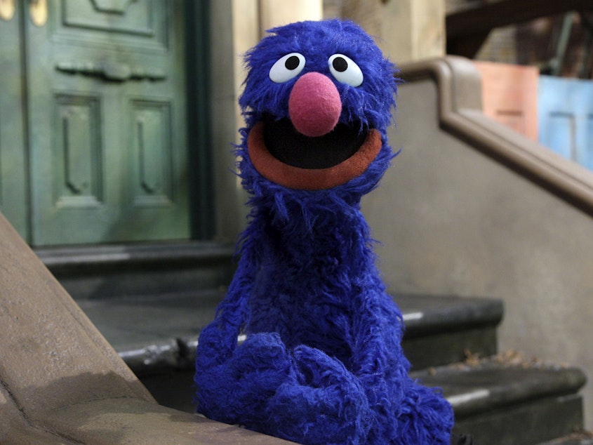 caption: Grover, pictured on "Sesame Street" in 2011, announced on Monday that one of his many jobs is in journalism. The social media response underscored the precarious state of the industry.