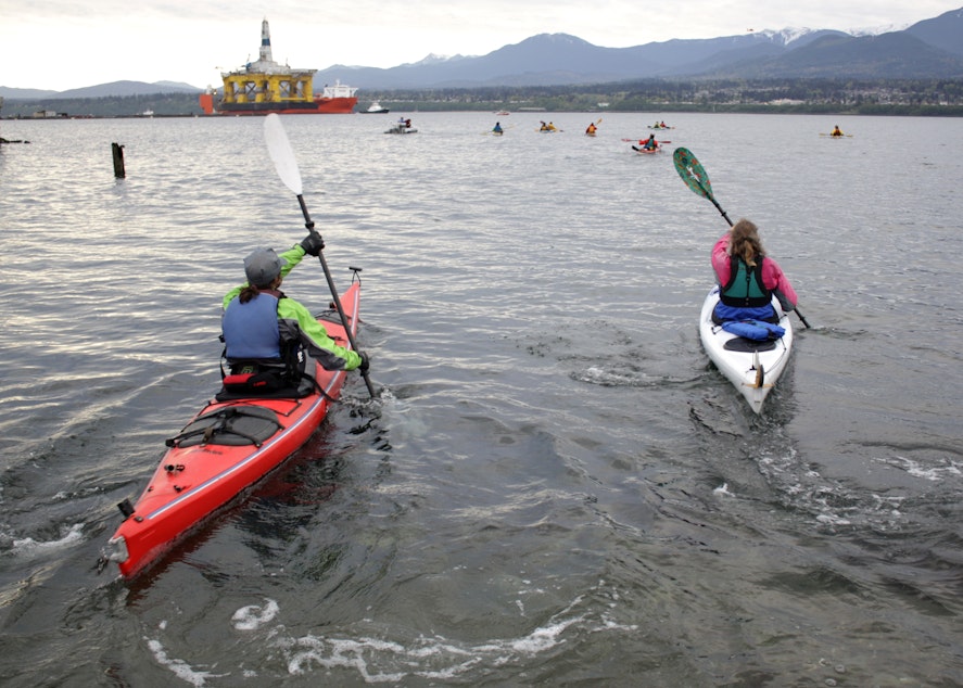 caption: Kayakers protesting the arrival of Shell's Polar Pioneer rig in Port Angeles in April