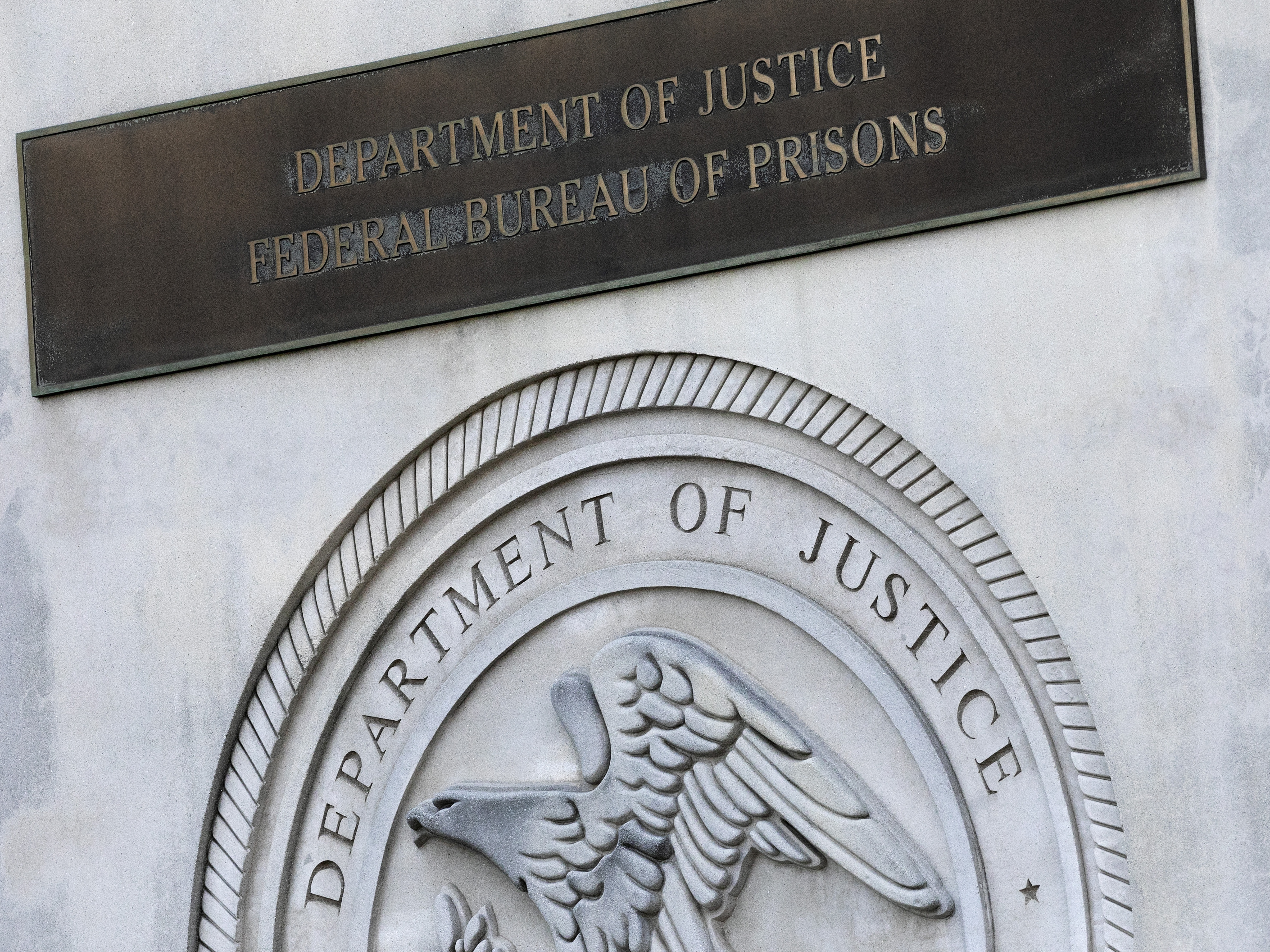 caption: A sign for the Department of Justice Federal Bureau of Prisons is displayed in the Brooklyn borough of New York, July 6, 2020.