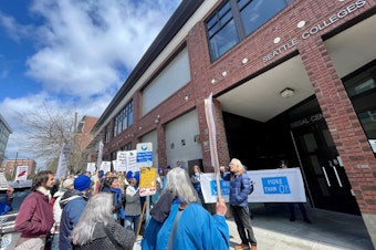 caption: A group of Seattle Colleges staff protests on April 11 outside the community college district's headquarters in Capitol Hill. They called on their employers to provide equitable wages and more resources to students.