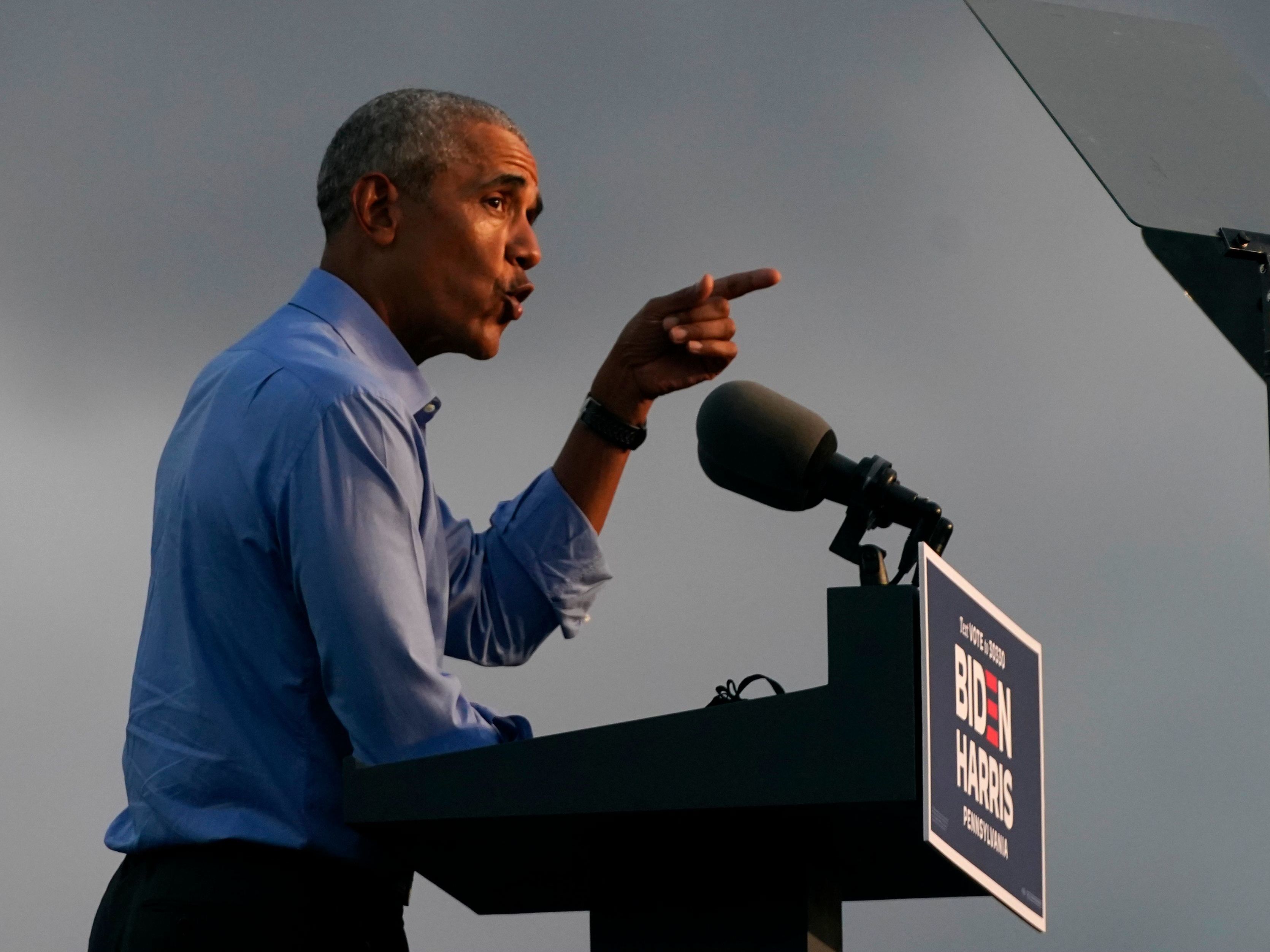 caption: Former President Barack Obama addresses Joe Biden-Kamala Harris supporters during a drive-in rally Wednesday in Philadelphia.