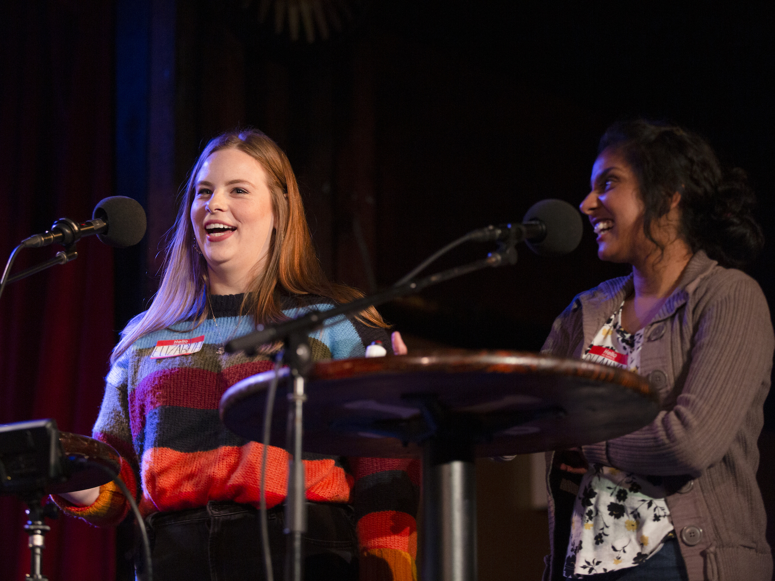 caption: Elizabeth Filipovich and Dhanya Sridhar face-off in a game on <em>Ask Me Another</em> at the Bell House in New York.