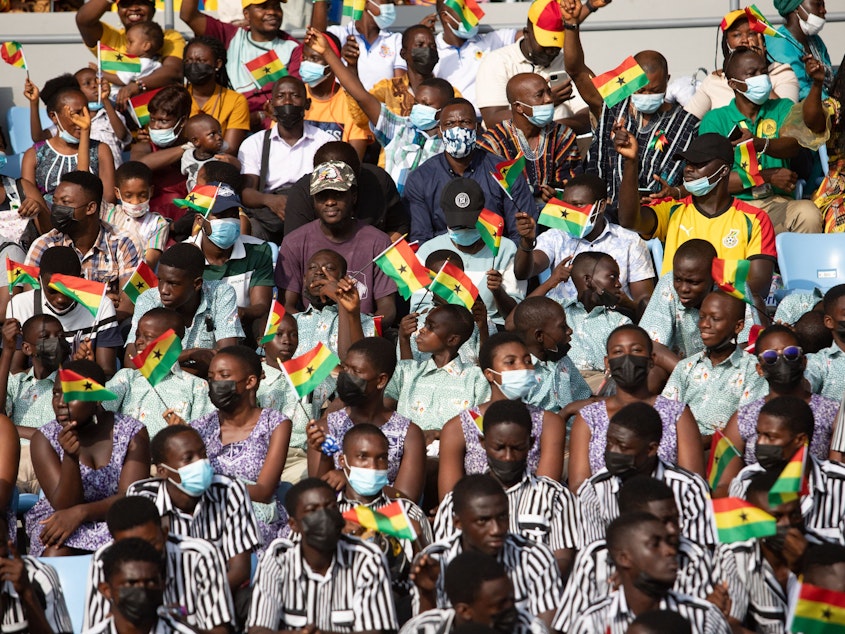 caption: Students cheers from the stands during the celebrations for Ghana 65th Independence Day on March 6, 2022. The country gained independence on March 6, 1957. The author of this article recalls his boyhood celebrations — which involved uniforms, marching and a free bottle of soda.