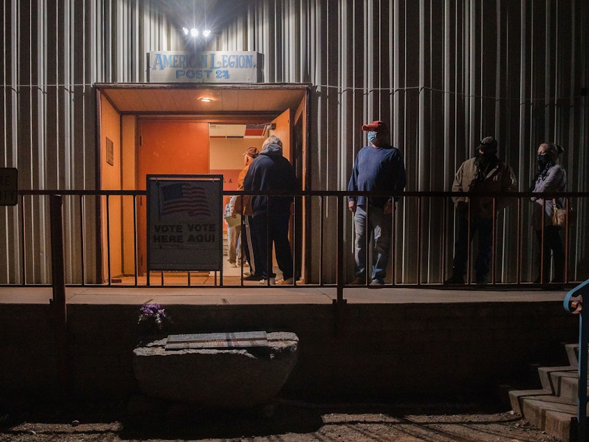 caption: People wait in line to vote early on Election Day 2020 in Tombstone, Ariz., in Cochise County. The county's Republican-led leadership has voted to delay certifying its 2022 election results, despite a state deadline on Monday.