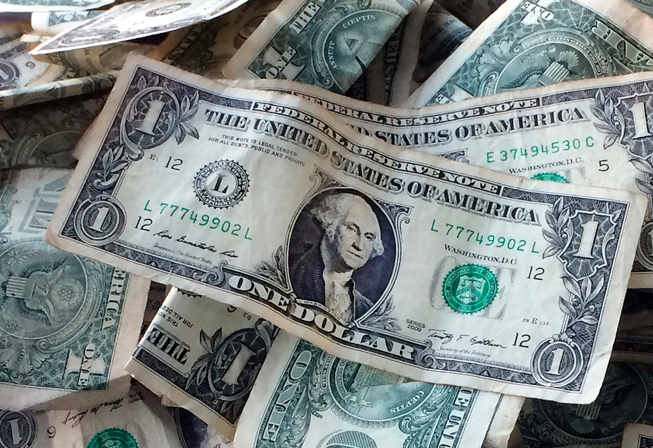 The $15 dollar minimum wage could boost pay for 17 million but some workers might lose their jobs, says newer reports. (Mark Lennihan, AP Photo)