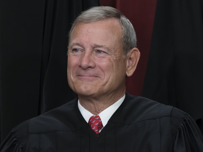 caption: Chief Justice of the United States John Roberts is shown joining other members of the Supreme Court as they pose for a new group portrait, at the Supreme Court building in Washington, Friday, Oct. 7, 2022.