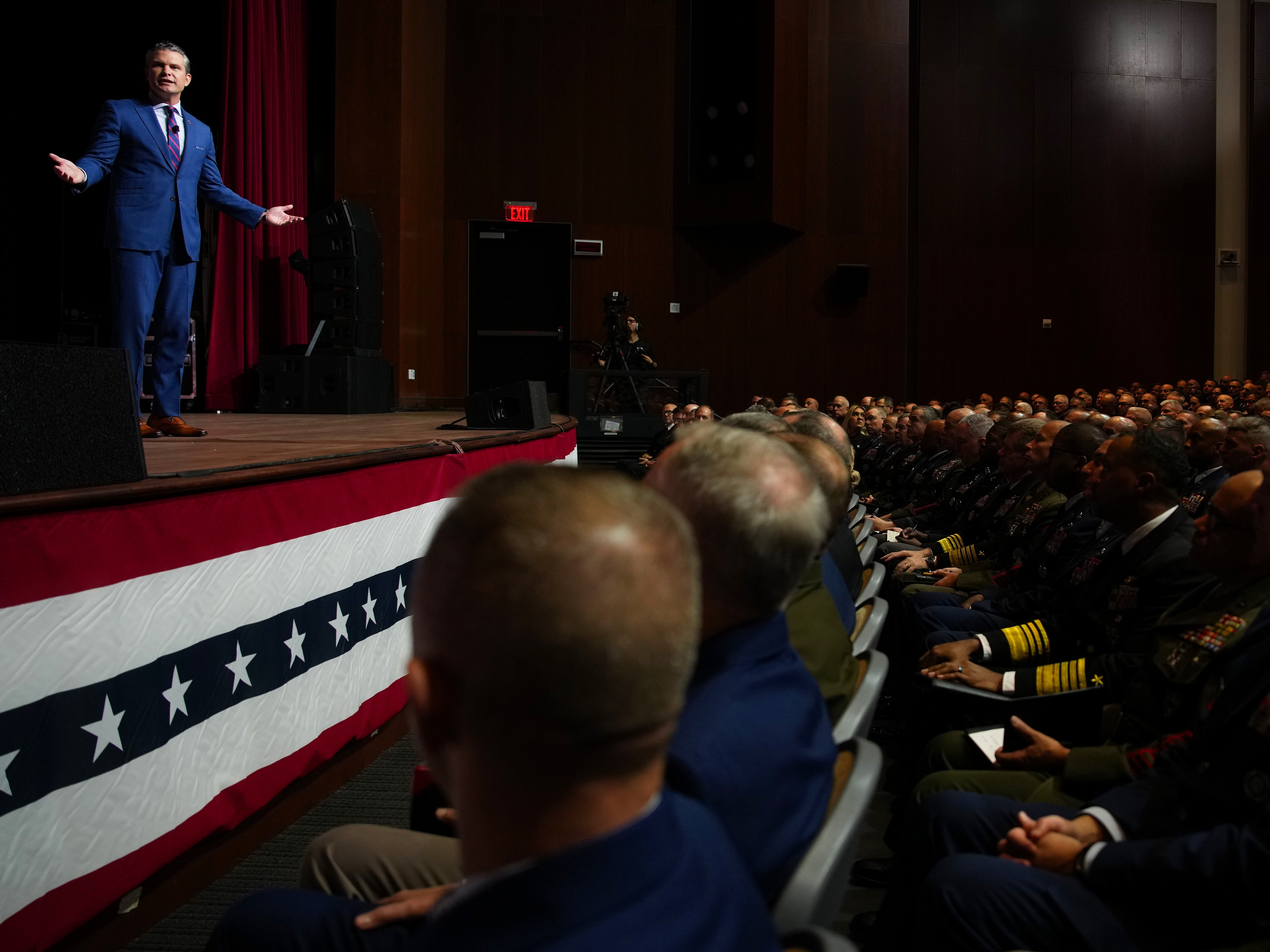 caption: Defense Secretary Pete Hegseth speaks to senior military leaders at Marine Corps Base Quantico on Sept. 30, in Quantico, Va. In an unprecedented gathering, almost 800 generals, admirals and their senior enlisted leaders have been ordered into one location from around the world on short notice.