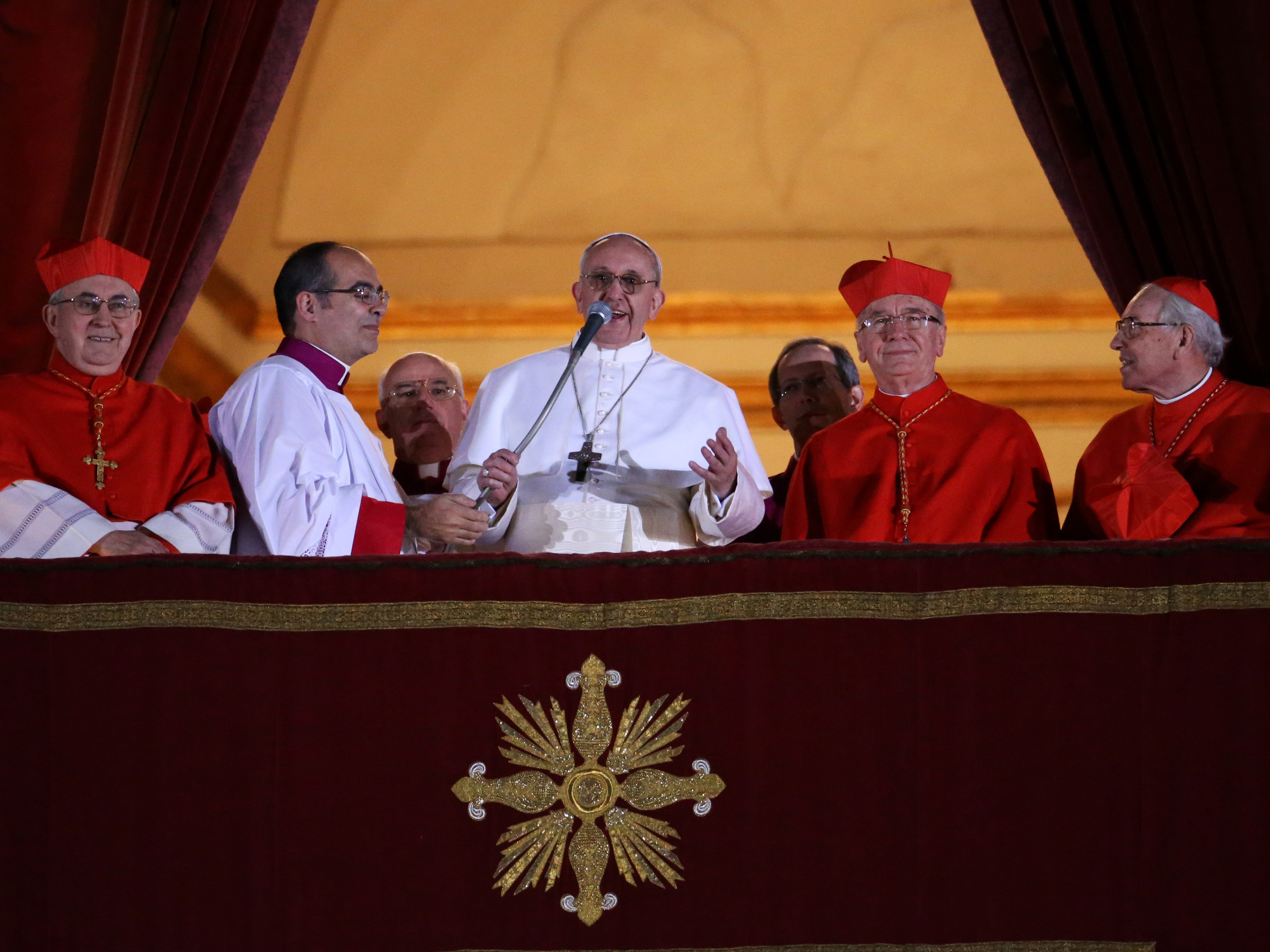 caption: Newly elected Pope Francis I speaks to the waiting crowd from the central balcony of St Peter's Basilica in March 2013 in Vatican City, Vatican.
