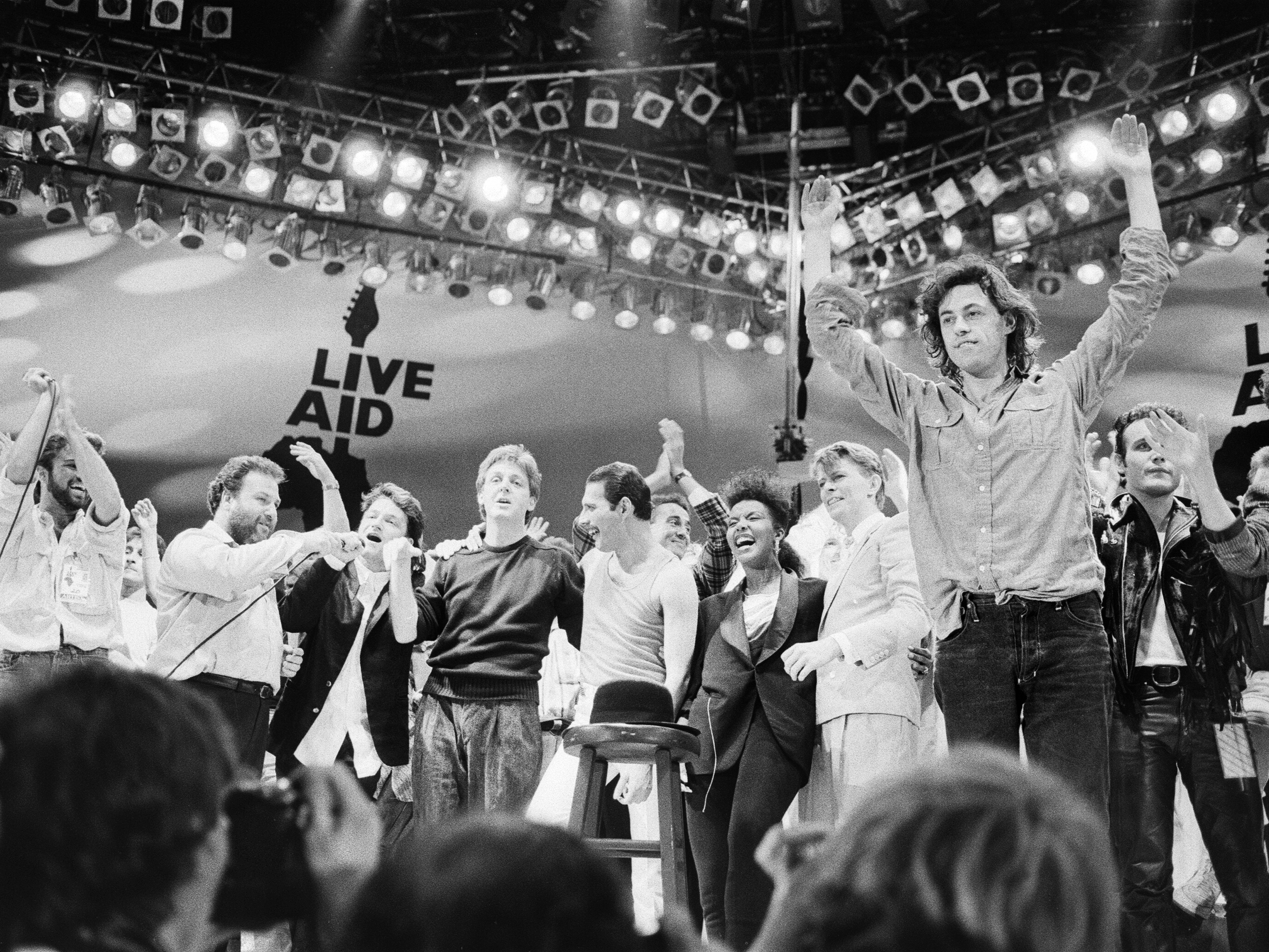 caption: On July 13, 1985, Live Aid held benefit concerts in London and Philadelphia that raised well over $100 million to address the famine in Ethiopia — and the U.S. created a system called FEWS NET to gather data and alerts governments and aid groups about possible future famines. Above: Performers on stage for the grand finale of the U.K. event.
