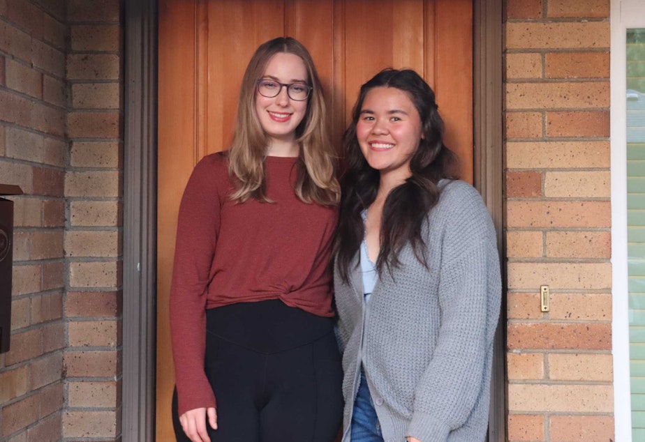 caption: Natalie Newcomb, KUOW's weekend announcer/reporter, stands with her roommate Annaka in front of their new home.