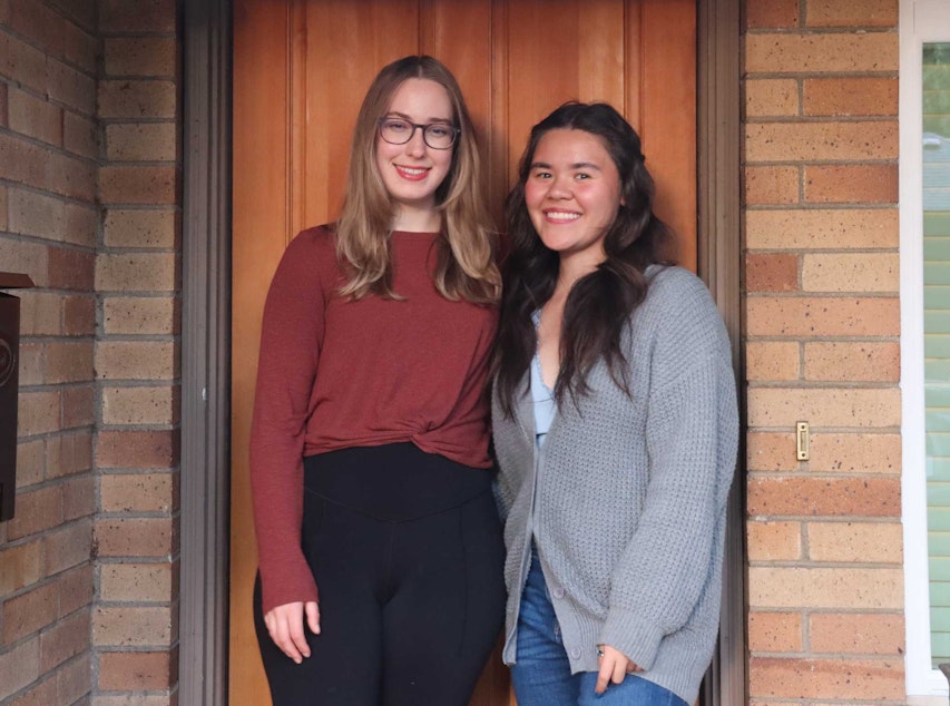 caption: Natalie Newcomb, KUOW's weekend announcer/reporter, stands with her roommate Annaka in front of their new home.