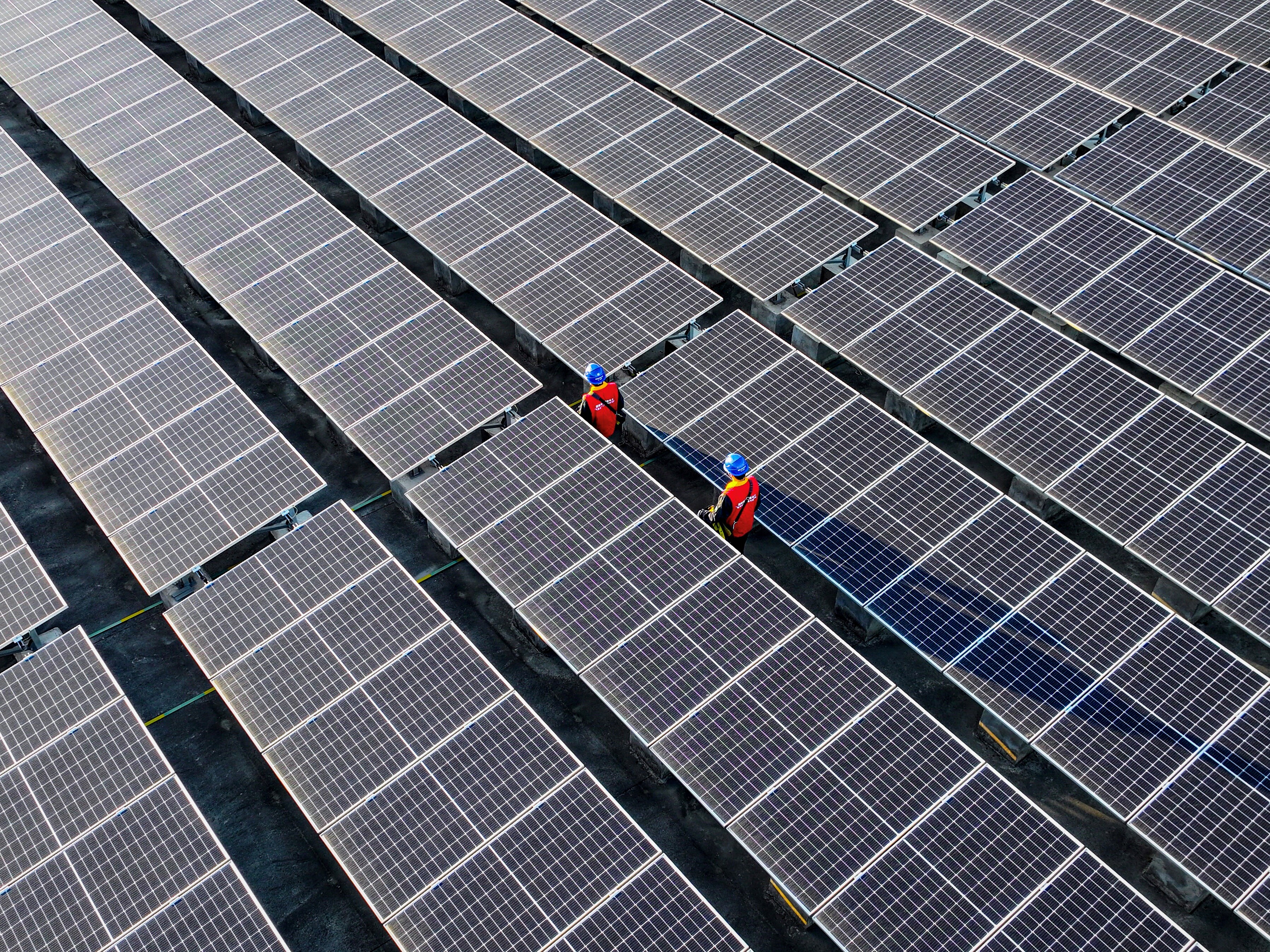 caption: Renewable energy capacity is growing rapidly, especially in China, where this rooftop solar array is installed. The increasing use of sources like wind and solar power is driving down greenhouse gas emissions around the globe.