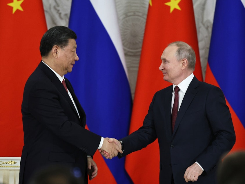 caption: Russian President Vladimir Putin, right, and Chinese President Xi Jinping shake hands after speaking to the media during a signing ceremony following their talks in Moscow on Tuesday.