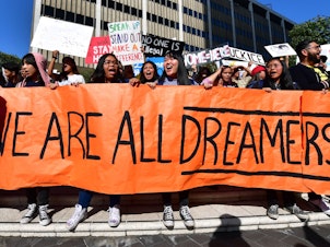 caption: Students and supporters of the Deferred Action for Childhood Arrivals rally in downtown Los Angeles in November while the U.S. Supreme Court heard arguments about the program. The court's ruling Thursday will uphold DACA for now.