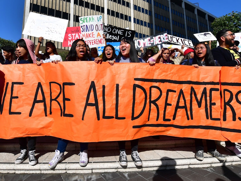 caption: Students and supporters of the Deferred Action for Childhood Arrivals rally in downtown Los Angeles in November while the U.S. Supreme Court heard arguments about the program. The court's ruling Thursday will uphold DACA for now.