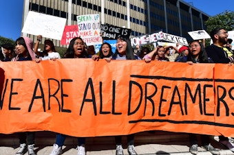 caption: Students and supporters of the Deferred Action for Childhood Arrivals rally in downtown Los Angeles in November while the U.S. Supreme Court heard arguments about the program. The court's ruling Thursday will uphold DACA for now.