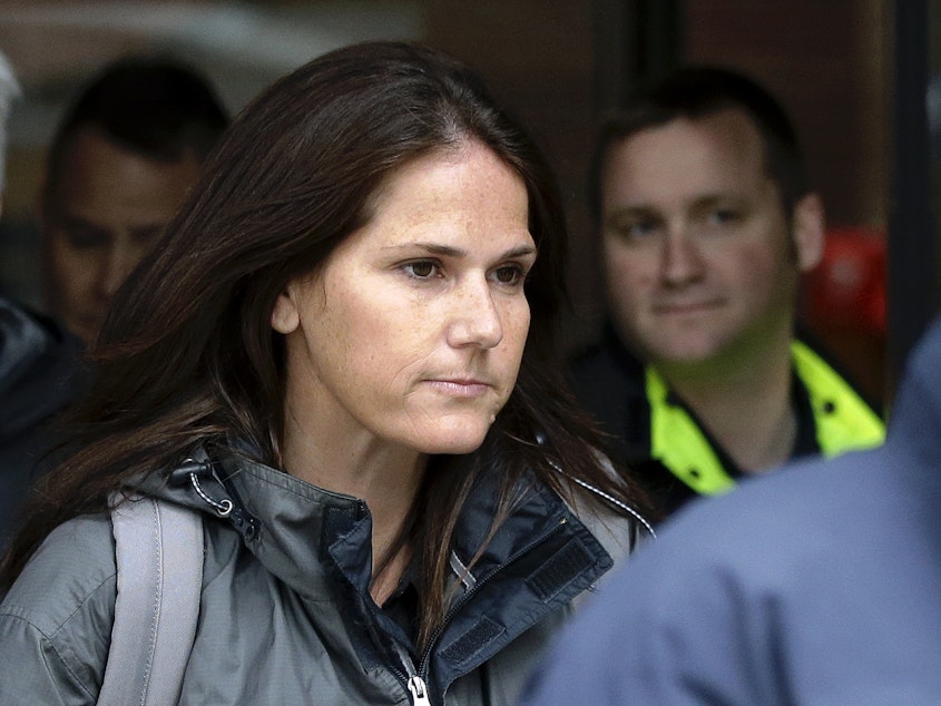 caption: Former University of Southern California soccer coach Laura Janke exiting a Boston federal court Tuesday, where she pleaded guilty to charges in a nationwide college admissions bribery scandal.