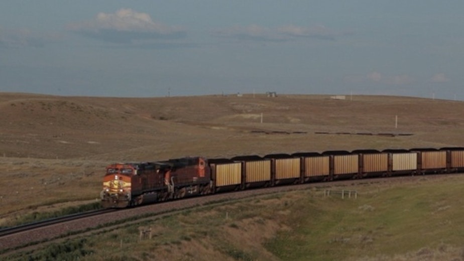 caption:  A coal train moves through Wyoming where the coal is mined from the Powder River Basin.