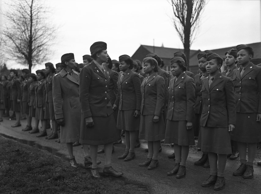 caption: Somewhere in England, Maj. Charity E. Adams, Columbia, S.C., and Capt. Abbie N. Campbell, Tuskegee Institute, Tuskegee, Ala., inspect the first contingent of Black members of the Women's Army Corps assigned to overseas service.