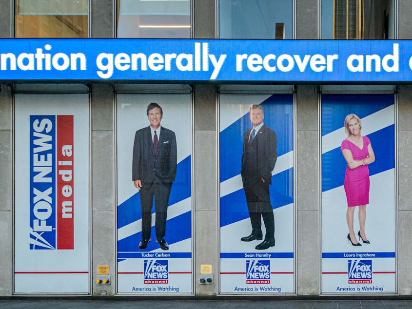 caption: Outside the Fox News headquarters building in New York City.
