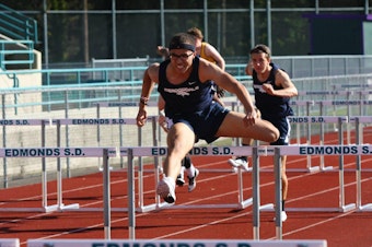 caption: Christapherson Grant runs the 110-meter hurdles race at Edmonds Stadium in spring 2015.