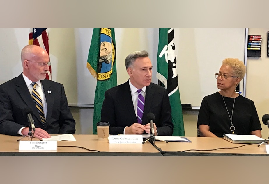 caption: Seattle Mayor Tim Burgess, King County Executive Dow Constantine and Deputy Executive Rhonda Berry at a press conference announcing the intent to move youth detention oversight to Public Health Seattle King County.