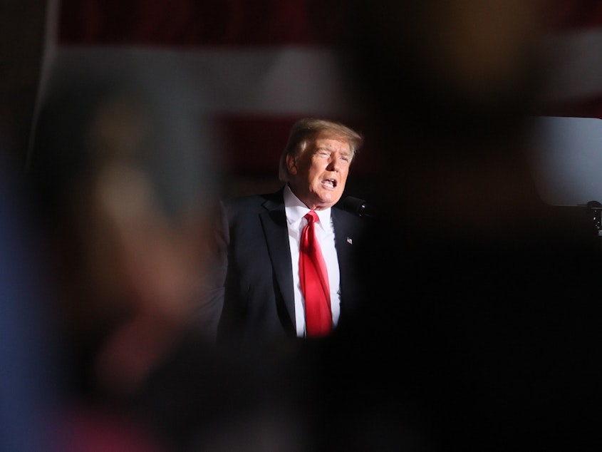 caption: Former President Donald Trump speaks to supporters during a rally at the Iowa State Fairgrounds in Des Moines on Oct. 9.