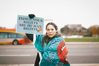 caption: Bernadette Demientieff of the Gwich'in Steering Committee participates in a December 2017 event in Washington, D.C., where advocates pushed Congress to protect the Arctic National Wildlife Refuge from oil development.