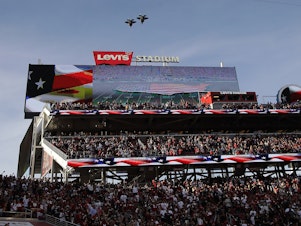 caption: Military planes fly over Levi's Stadium on Thursday during the playing of the national anthem. A cheerleader took a knee during the pre-game anthem, and may be the first NFL cheerleader to do so.