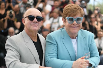 caption: Elton John and Bernie Taupin promote the film <em>Rocketman</em> at the Cannes Film Festival in 2019.