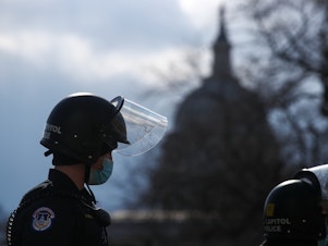 caption: A U.S. Capitol Police officer stands guard outside the Capitol ahead of the inauguration for President Biden on Jan. 20.