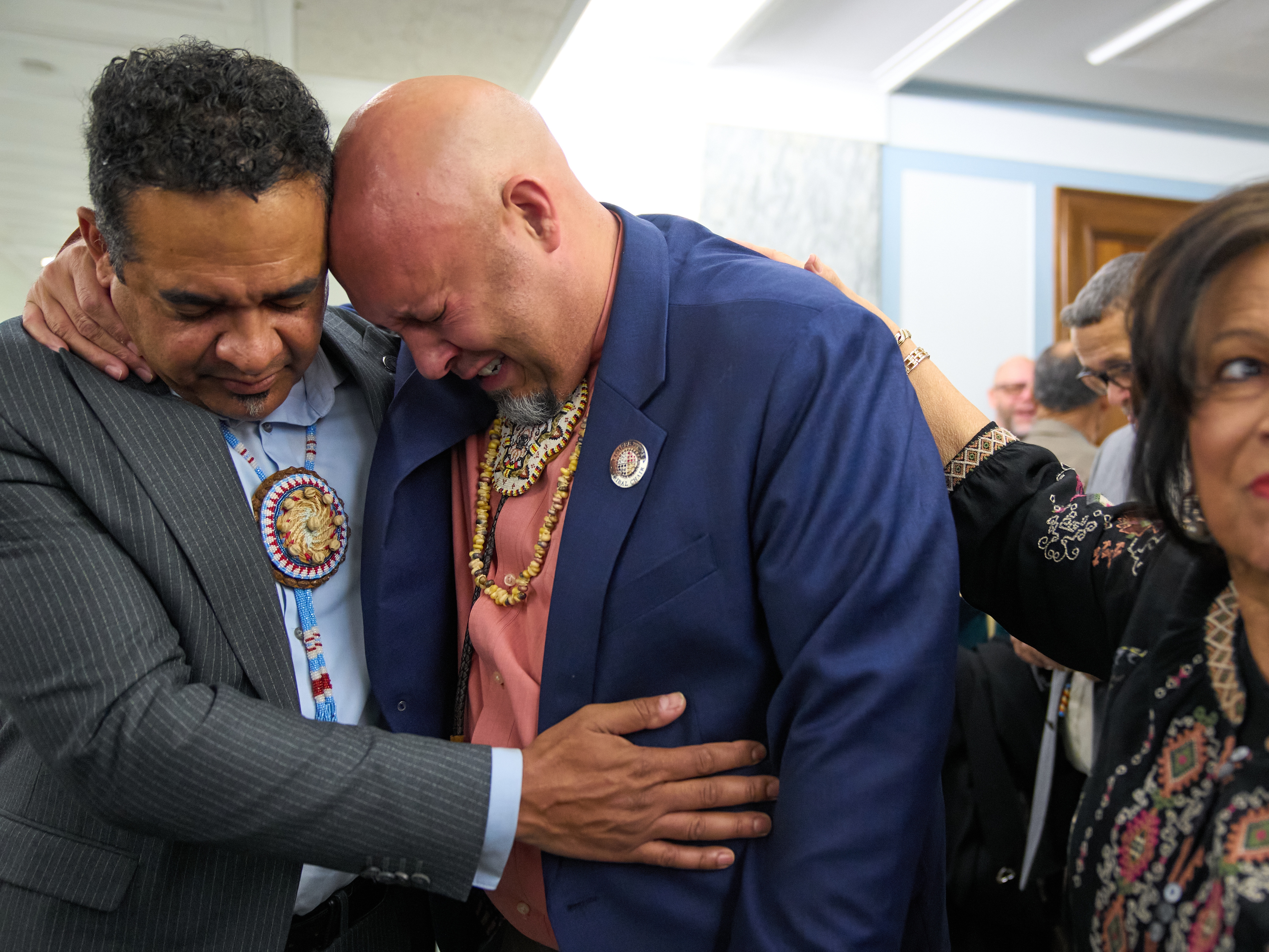 caption: John Lowery, chairman of the Lumbee Tribe of North Carolina and a state representative (center) is comforted, as he cries tears of joy. Lowery and other members of the tribe gathered in Washington, D.C., to mark the passage of a bill granting full federal recognition on Wednesday.