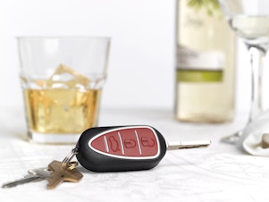 caption: Car keys are shown by glasses with alcohol in this stock photo illustration. Companies are developing technology that would allow cars to stop people from driving when drunk.