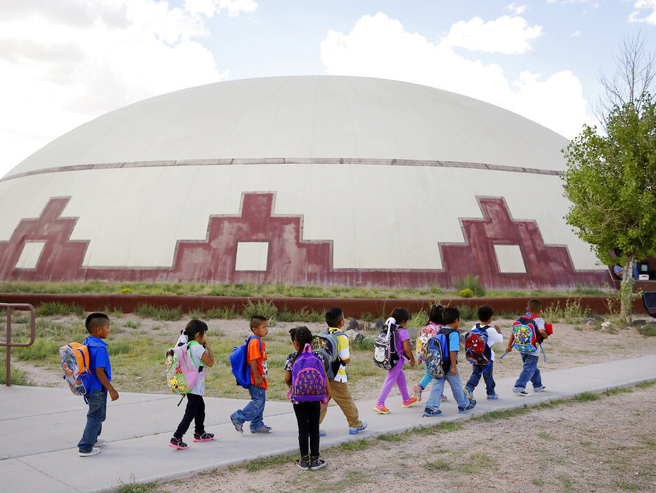 caption: Students walk between buildings in September 2014 at the Little Singer Community School in Birdsprings, Ariz., on the Navajo Nation.